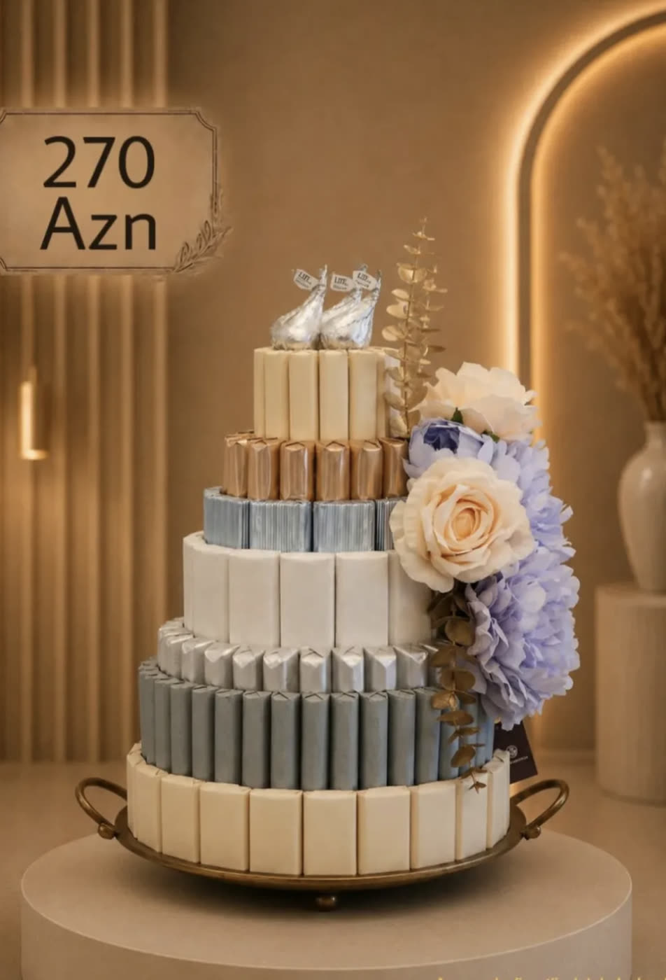 Tiered tower of wrapped chocolate bars crowned with roses