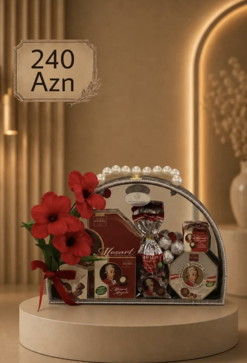 Hamper of Mozart chocolates with red anemones and a pearl handle