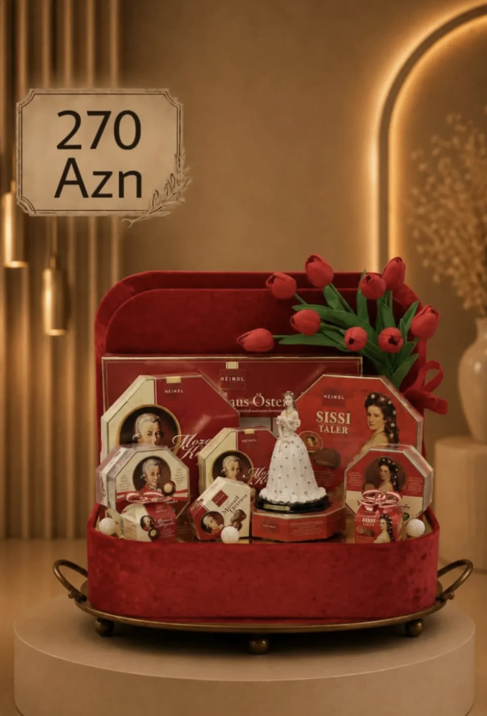 Red velvet suitcase hamper filled with Mozart chocolates and tulips